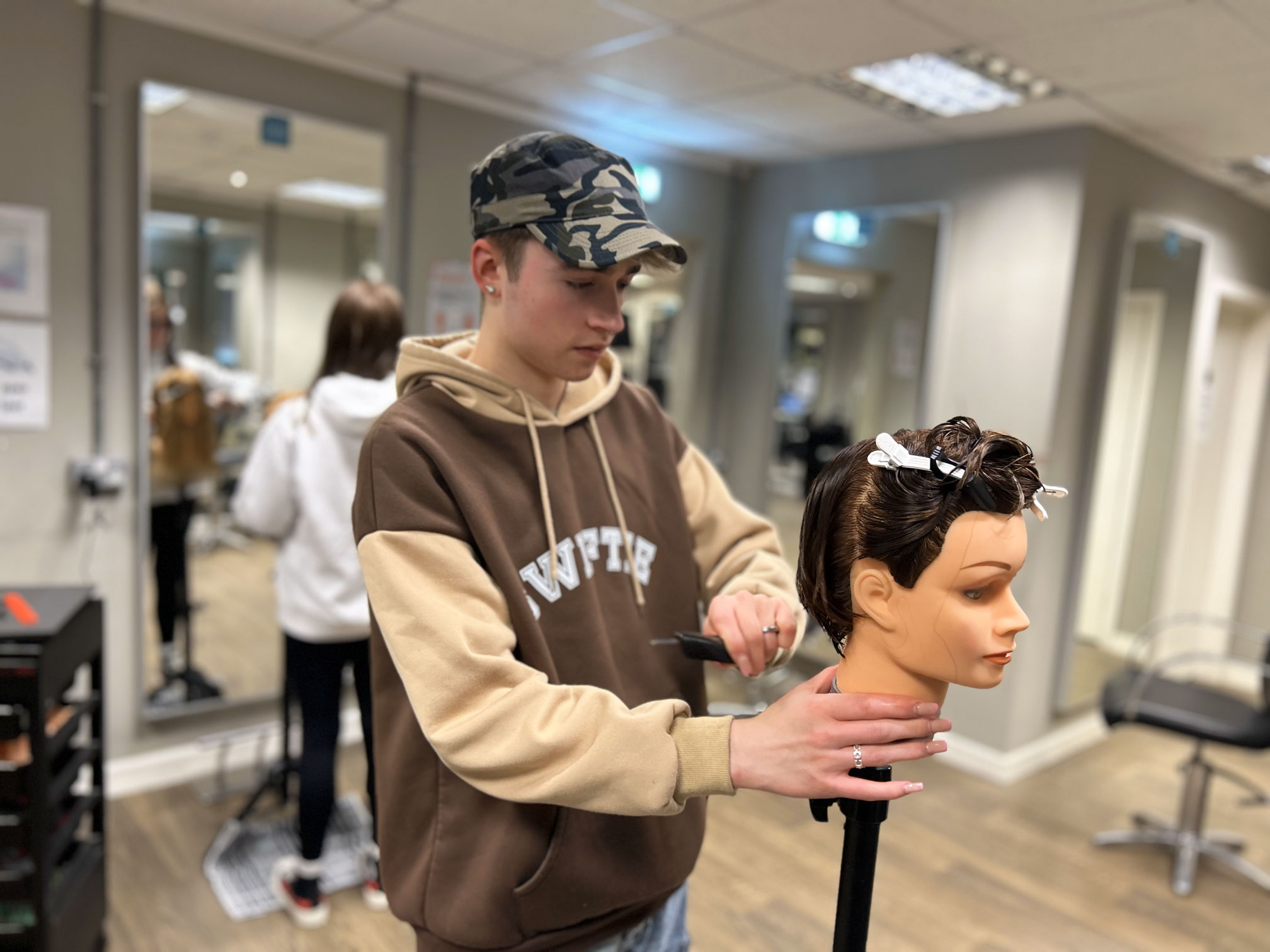 Hairdressing learner, Talek cutting hair